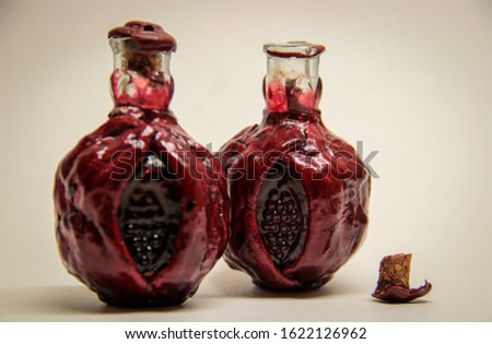 two bottles of red pomegranate wine, wine, decorative bottles in  pomegranate shape