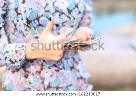 Closeup of female hand using a smart phone.