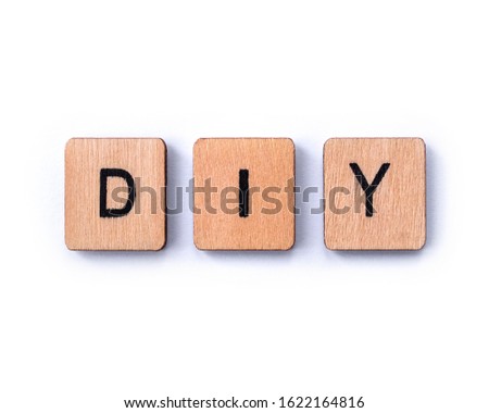 The abbreviation DIY - meaning Do It Yourself - spelt with wooden letter tiles on a white background. Royalty-Free Stock Photo #1622164816