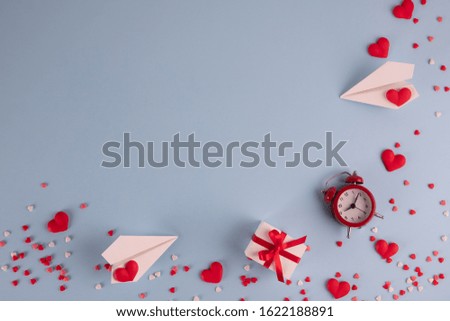 Valentine's Day background. Gifts, confetti, paper plane on pastel blue background. Valentines day concept. Flat lay, top view, copy space
