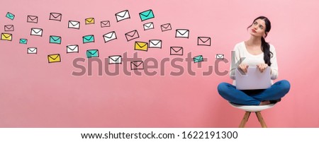 Many emails with young woman using a laptop computer