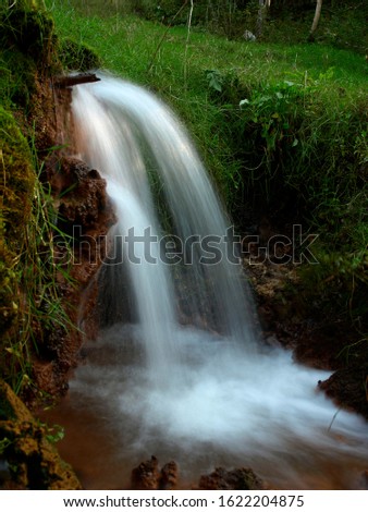 Soft waters running on rocks. Close-up of running water as a picture background