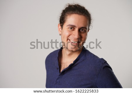 portrait of funny men with blue shirt in front of white isolated background in the studio