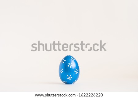 Easter blue egg with with floral pattern isolated on white background. Minimal easter concept. Happy Easter card with copy space for text Top view, flatlay. 