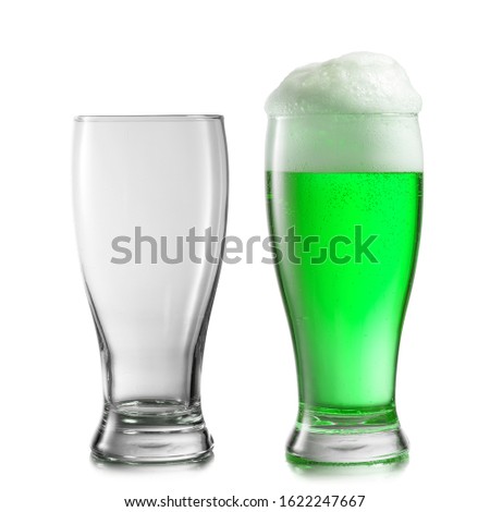 Composition from two glasses empty and filled fresh natural green beer drink with thick foam on a white background, copy space. Happy St.Patrick 's Day concept.