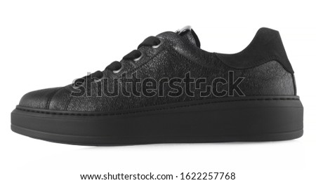 Black female leather sneakers isolated on white background