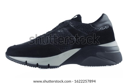 Black female leather sneakers isolated on white background