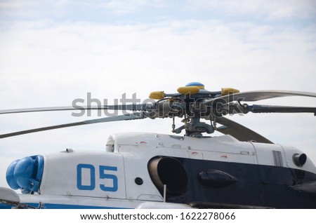 Fragment of helicopter screw engine close up against blue sky. Propeller of the ukrainian heli transporter
