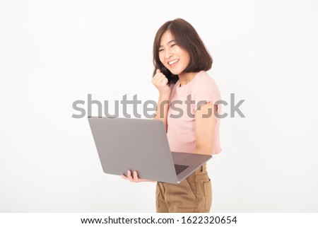 Cute Asian teen woman is working with computer on white background 