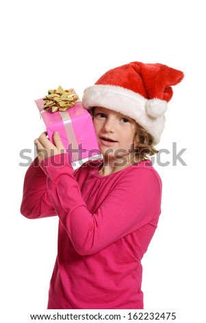little girl hugging christmas present