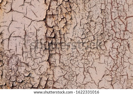 Cracks in old brown paint