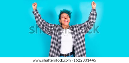 young afro american woman with success expression isolated on color background