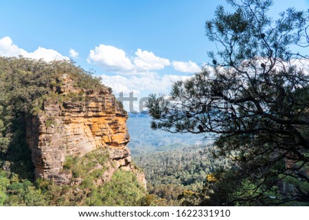Panoramic Blue Mountains Australia. Dramatic views of rock formations, valley, landscape, and green rainforest jungle. Adventure, freedom, nature concepts. Tourist mountain trek. Shot in Sydney, NSW.