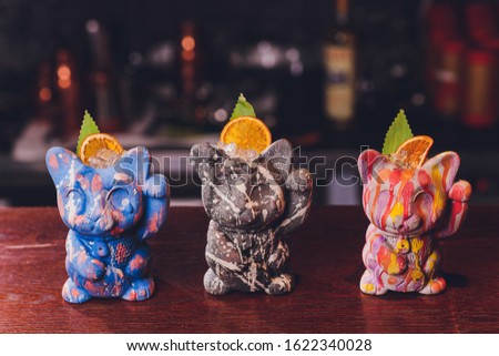 cat cocktails drinking vessel on the background of a wooden bar.
