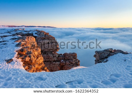 Fog in the mountains at sunrise in winter
