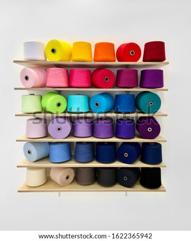 skeins of thread in a rainbow color on a shelf
