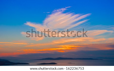 Bright colorful sunset on the sea with beautiful clouds