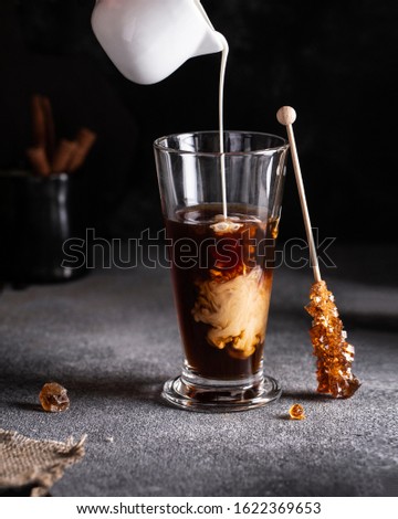 cold coffee with ice and cream in a long glass on the table summer drink Royalty-Free Stock Photo #1622369653