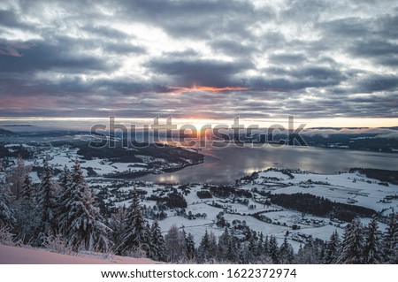 Sunrise, sunset picture in winter, in Scandinavia. Snowie mountains and trees. Travel photography, copy space.