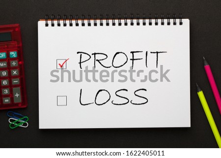 Profit and Loss check boxes written on notepad with pencil and calculator a side. Business concept.