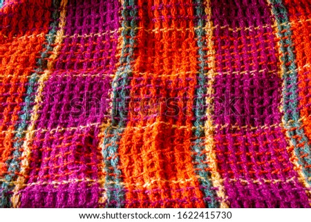 An old plaid with a multicolored check. Background.
