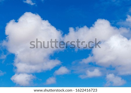 Bright blue, partly cloudy sky