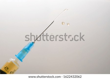 Close-up of a medical syringe with a drug on a white-gray background