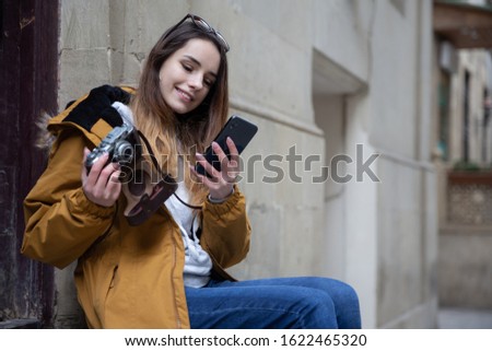 Photo of young tourist girl exploring streets of Baku. Moody photos of teenager girl visiting old city and taking photos of the city.