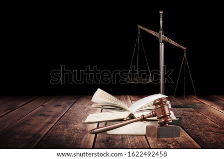 Justice Scales and books and wooden gavel on table