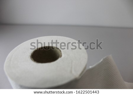 A roll of paper tissue. Toilet paper tissue on white table.