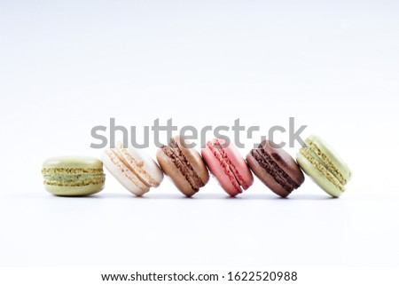 Cake macaron or macaroon on turquoise background from above, colorful almond cookies, pastel colors