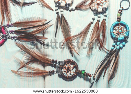 Ethnic dreamcatchers on a wooden background. Dream catchers, indian amulet, feathers, decoration.