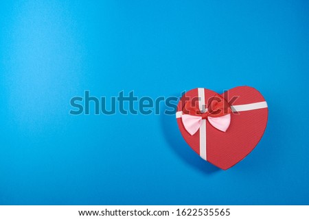 The Background Of Valentine's Day. Gifts, flowers, heart, box in pastel blue colors. The Concept Of Valentine's Day. Flat sunbed, top view, copy space