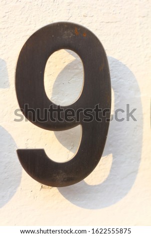 steel plate number nine, no.9 on white wall
