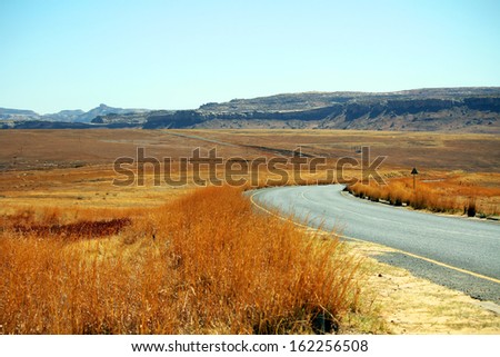 Empty asphalt road in Golden Gate Highlands National Park, South Africa