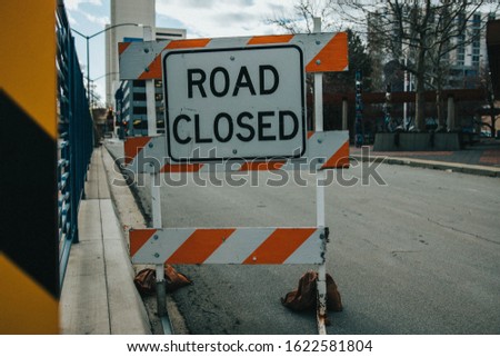 A "Road Closed" sign on the side of an urban street 
