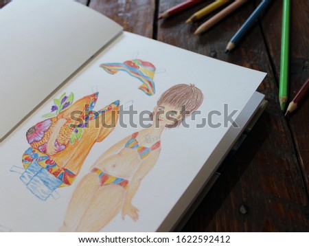 Hand drawn body positive illustration in a sketchbook on the table with colored pencils. A plump Caucasian girl in a swimming suit and her outfit consisting of a hat, tunica, bag with flowers.