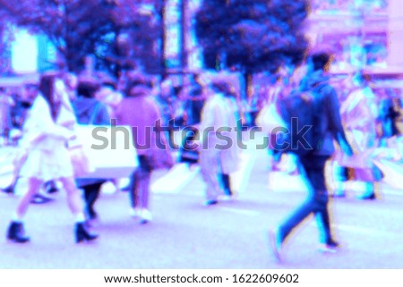 Abstract blurred image holographic foil style of people walking 
