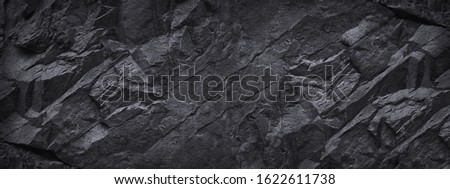 Black white stone rock granite background for design. Dark gray. Grunge.  Mountain surface texture. Nature. Close-up. Volumetric. Rocky. Backdrop. Wide banner. Panoramic.