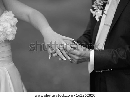 Hands of wedding couple. Picture in black and white. Togetherness.