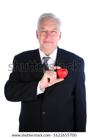 Valentines Day. A man holds a Valentine's Day Heart. Isolated on white. Room for text. Clipping Path. Hearts represent love world wide. Valentine's Day is when people give each other gifts of love. 