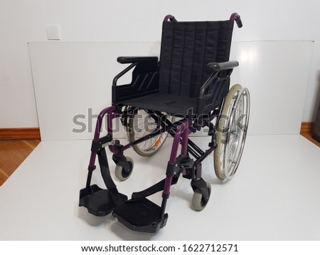Black wheelchair for disabled people on white background 