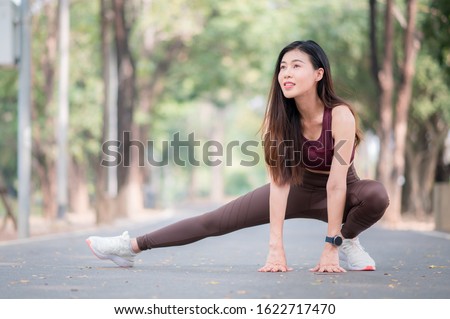 Sport women doing stretchinh exercise during outdoor cross training workout. Healthcare concept