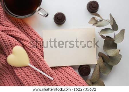 card mock up with eucalyptus and knitted fabric. heart candies. coffee cup. valentines day