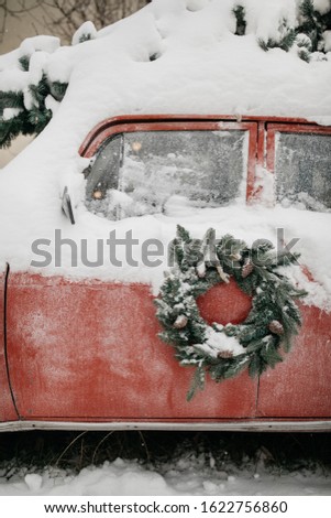 Christmas wreath on red car