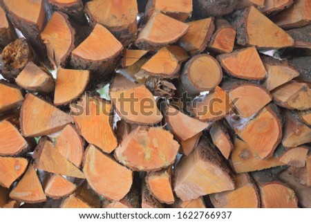 Stack of firewood. Timber for fireplace. Fuel for rural houses.