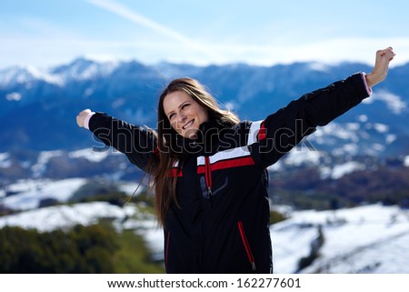 Beautiful young woman enjoying a hiking trip in the mountains, selective focus