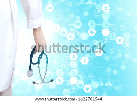 Hand of practitioner with stethoscope