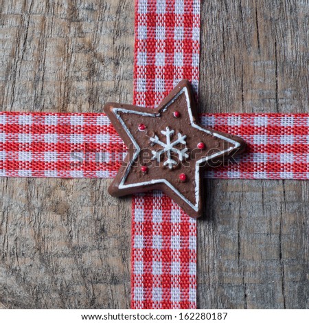 Red christmas ribbon on old wooden background