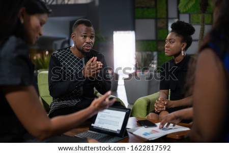 Black african business analyst in strategy meeting. Using hand gestures with serious and concerned tone Royalty-Free Stock Photo #1622817592
